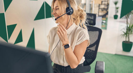 Friendly support specialist smiling while wearing a headset